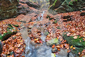 Waterfall in Tajovska dolina gorge near Tajov village during autumn