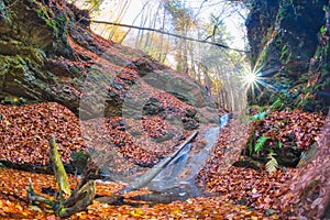 Waterfall in Tajovska dolina gorge near Tajov village during autumn sunset