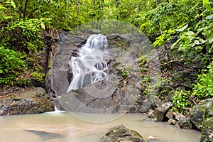 Waterfall in tropical rain forest jungle