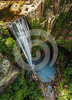 Waterfall tumbling over the sheer cliffs to idyllic waterhole