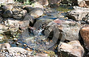 Waterfall tumbling slowly against rocks