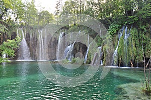 Waterfall into Turquoise Green Lake