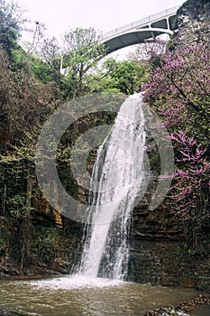 Waterfall under the arched bridge. National Botanical Garden in Tbilisi.