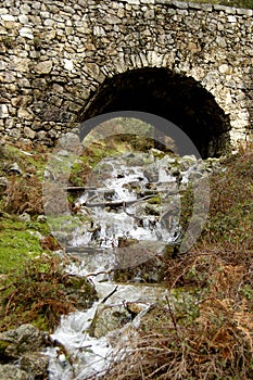 Waterfall under bridge