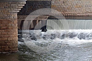 Waterfall under the city bridge