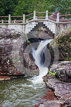 Waterfall under the stone bridge