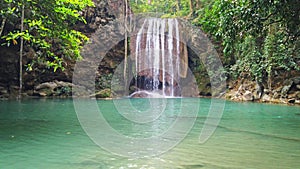 Waterfall water cascade near tree in forest