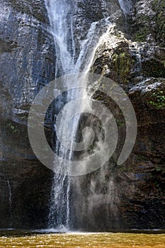 Waterfall water running down dark rocks