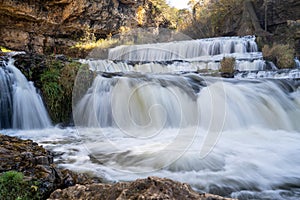 Waterfall at Willow River State Park in Hudson Wisconsin in fall. Daytime long exposure with silky water