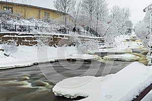 Waterfall in winter, strong current, frozen ice and trees in other. landscape photography Frost, ice, cold concept. Old