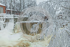 Waterfall in winter, strong current, frozen ice and trees in other. landscape photography Frost, ice, cold concept. Old