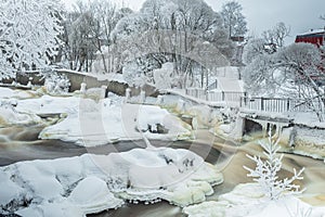 Waterfall in winter, strong current, frozen ice and trees in other. landscape photography Frost, ice, cold concept. Old