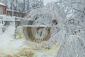 Waterfall in winter, strong current, frozen ice and trees in other. landscape photography Frost, ice, cold concept. Old