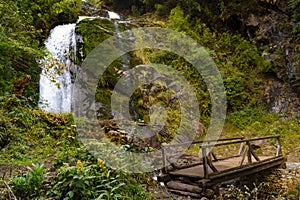 A waterfall with wooden bridge in Thangyam Village of Taplejung, Kanchenjunga Trek, Nepal