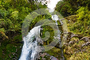 A waterfall with wooden bridge in Thangyam Village of Taplejung, Kanchenjunga Trek, Nepal