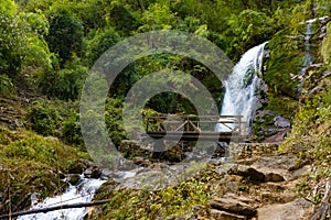 A waterfall with wooden bridge in Thangyam Village of Taplejung, Kanchenjunga Trek, Nepal