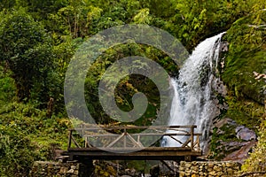 A waterfall with wooden bridge in Thangyam Village of Taplejung, Kanchenjunga Trek, Nepal