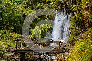 A waterfall with wooden bridge in Thangyam Village of Taplejung, Kanchenjunga Trek, Nepal