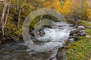 Waterfalls and autumn trees at Llorts in Andorra