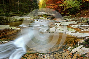 Waterfalls cascade in autumn forest. Beautiful colors of nature