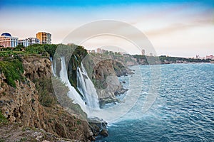 Waterfalls on Mediterranean sea coast in sunset light. Antalya, Turkey