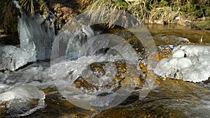 Waterfalls on mountain river slow motion view, clearness and freshness of nature. Winter sunny day.