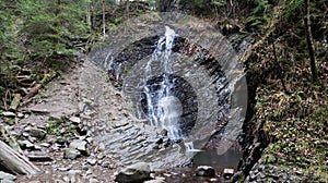 Waterfalls in a small canyon with stone walls. Beautiful cascade in the mountains. river in the Carpathians in the mountain autumn