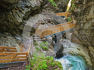 Waterfalls Stanghe Gilfenklamm localed near Racines, Bolzano in South Tyrol, Italy. Wooden bridges and runways lead through the photo