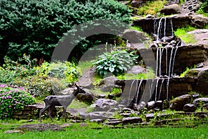 Waterfalls and statue of roe