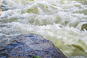 Waterflow. Water flowing over the rock. Mountain river