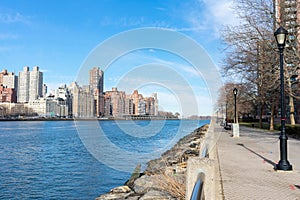 Waterfront along the East River at Roosevelt Island and looking towards the Upper East Side Skyline of New York City