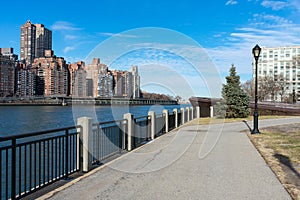 Waterfront along the East River at Roosevelt Island and looking towards the Upper East Side Skyline of New York City