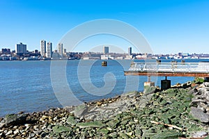 Waterfront along the Hudson River in Lincoln Square of New York City with a Clear Blue Sky