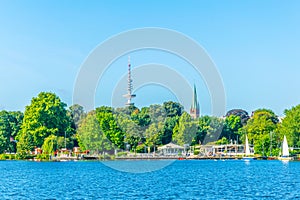 Waterfront of the aussenalster lake in Hamburg dominated by heinrich herz tower, Germany