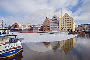 Waterfront of beautiful Old Town in Gdansk with old ships in ice.