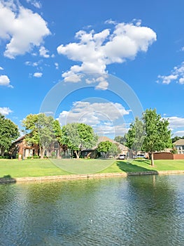 Waterfront houses with mature bold cypress trees and retaining wall near Dallas