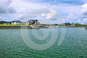 Waterfront houses with private boat jetties at Marsden Cove, near Whangarei, Northland, New Zealand, NZ