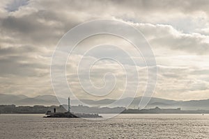 The waterfront of Livorno, Italy, under a dramatic early morning sky, seen from the sea