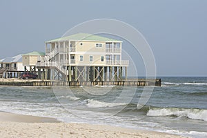 Waterfront modern rental house on stilts on beach near water