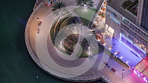 Waterfront promenade in Dubai Marina aerial night timelapse. Dubai, United Arab Emirates