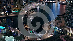 Waterfront promenade in Dubai Marina aerial night view. Dubai, United Arab Emirates