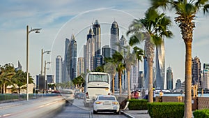 Waterfront promenade on the Palm Jumeirah with palms at road timelapse. Dubai, United Arab Emirates