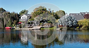 Waterfront property with doc and red canoe