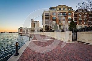 Waterfront residences and the Waterfront Promenade at sunset, at the Inner Harbor in Baltimore, Maryland
