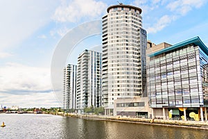 Waterfront residential and office buildings on a partly cloudy summer day