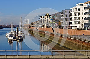 Waterfront of the Europa harbor in Bremen, Germany with moored sailing yachts and modern office and luxury apartment buildings