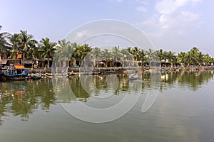 Waterfront view of Thu Bon River, at Hoi An ancient town historic district, UNESCO world heritage site. Vietnam.