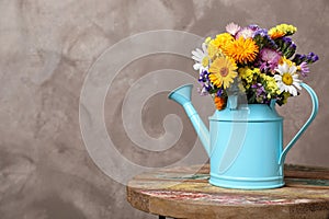 Watering can with beautiful wild flowers