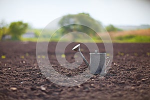 Watering can on the field