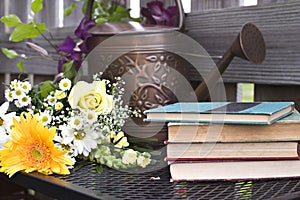 Watering can and old books